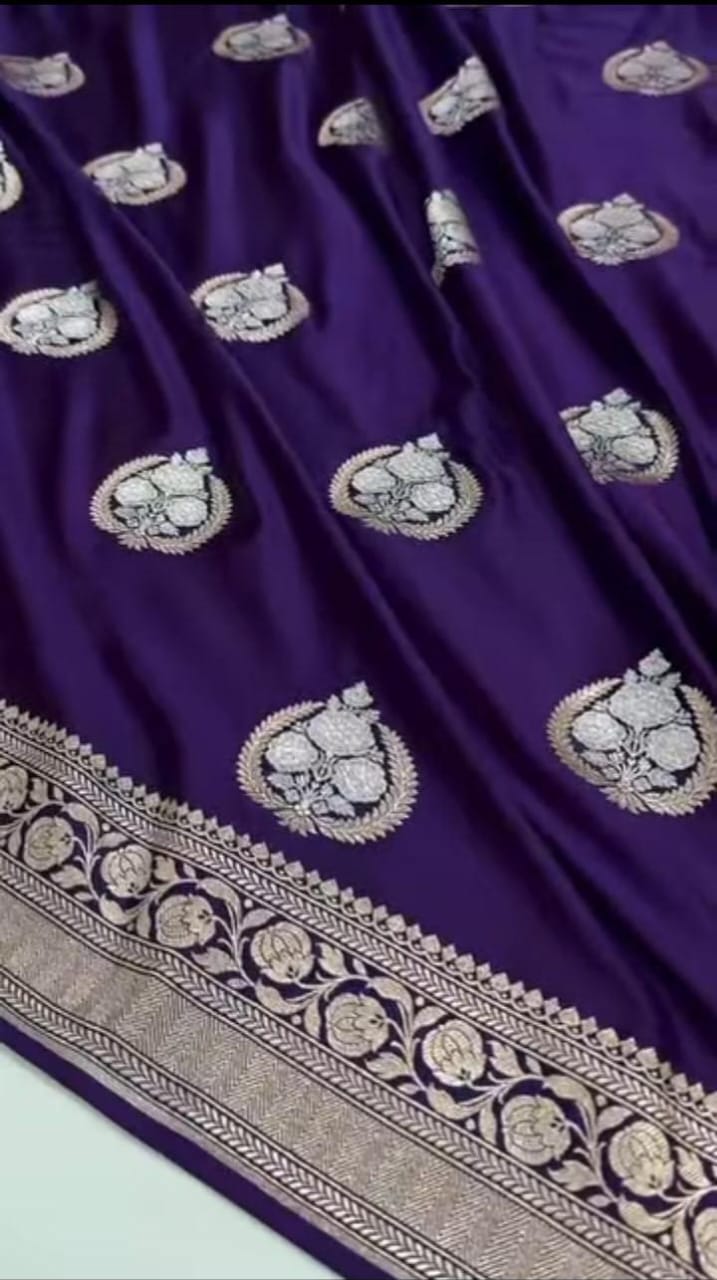 Purple fabric with intricate white embroidery on a light green background