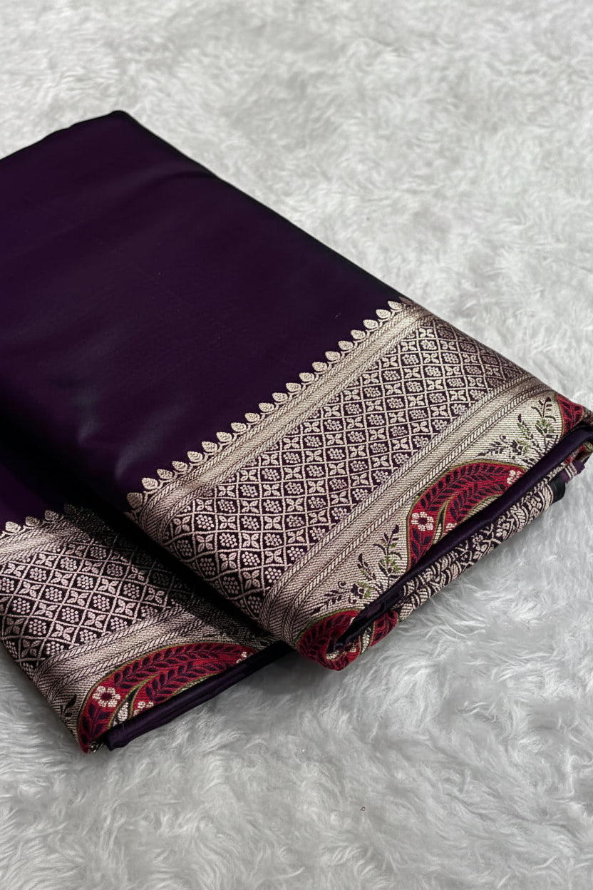 Folded purple saree with intricate patterns on a white surface, Zara box visible.