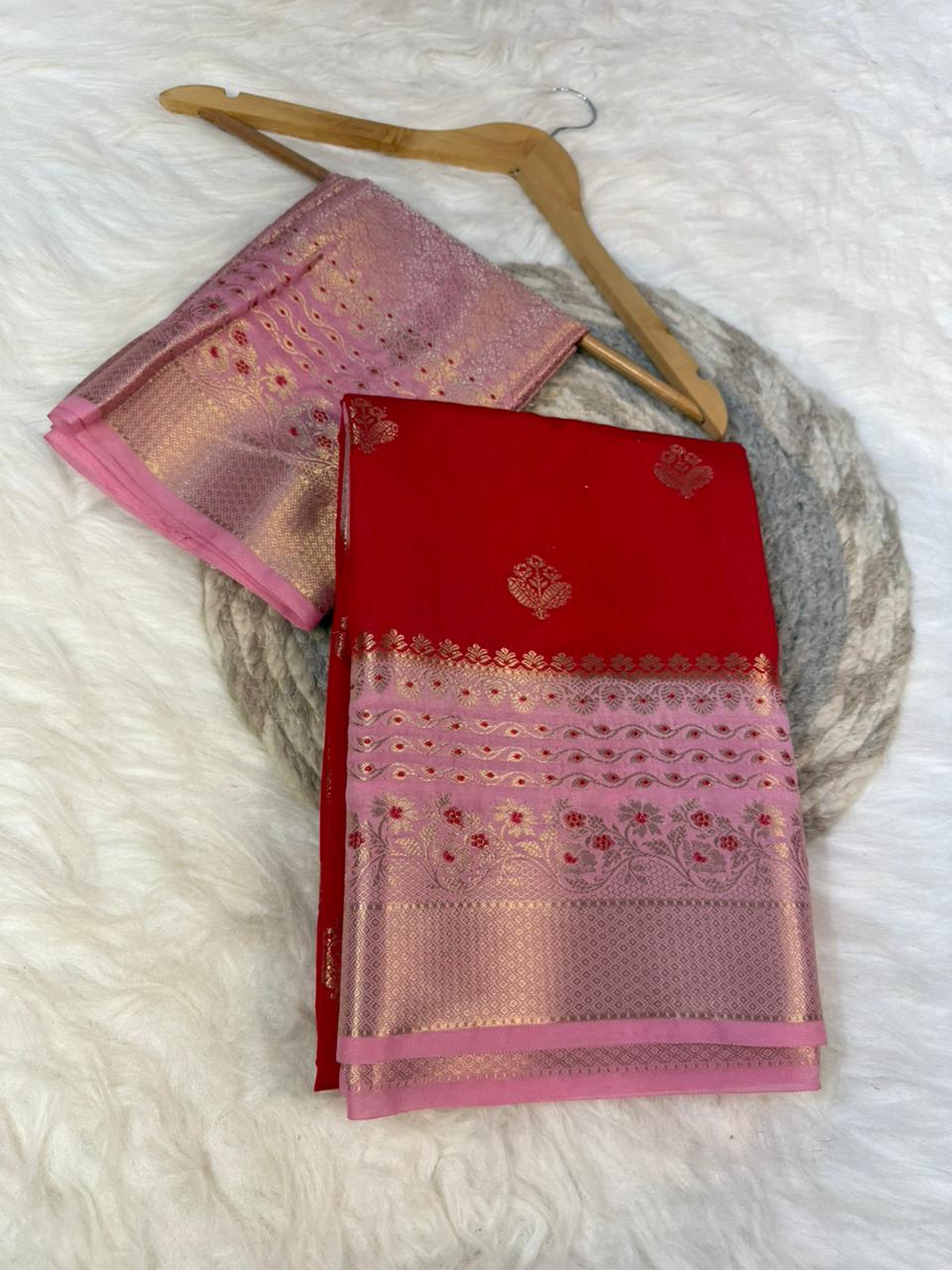 Red and pink saree with a hanger on a white background
