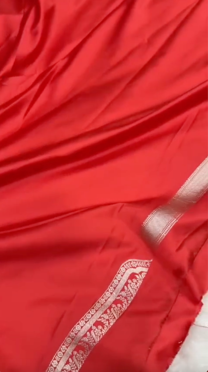 Red fabric with white embroidery on a plain background