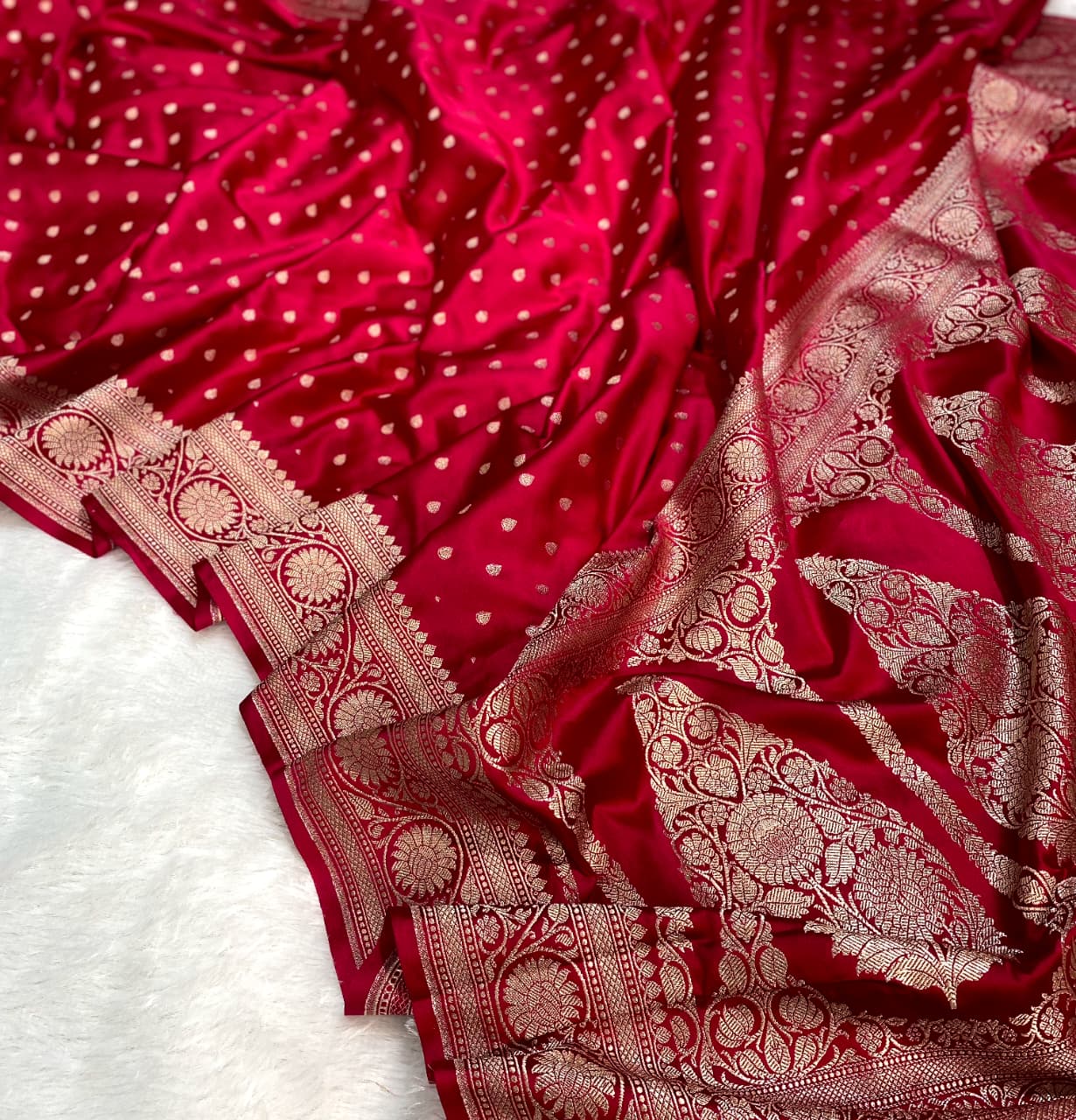 Red fabric with gold patterns on a white background