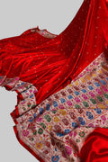 Red saree with a colorful pattern on a white surface
