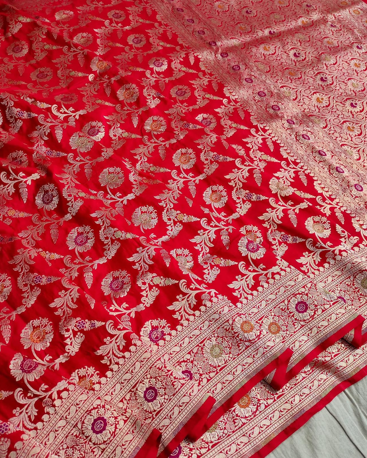 Red fabric with intricate white floral patterns