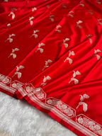 Red fabric with white floral embroidery on a white background