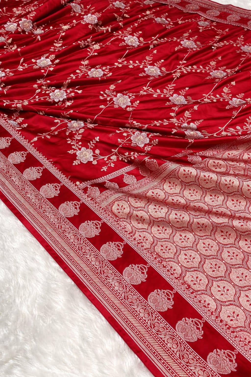 Red fabric with white floral patterns on a white background