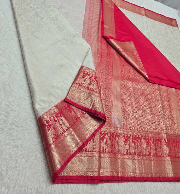 White saree with red border on a white surface