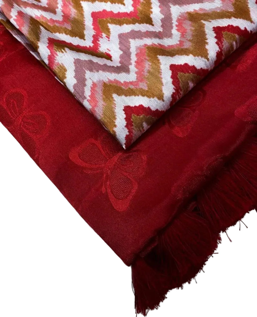 Red woven butterfly crèpe fabric with a patterned section on a white background