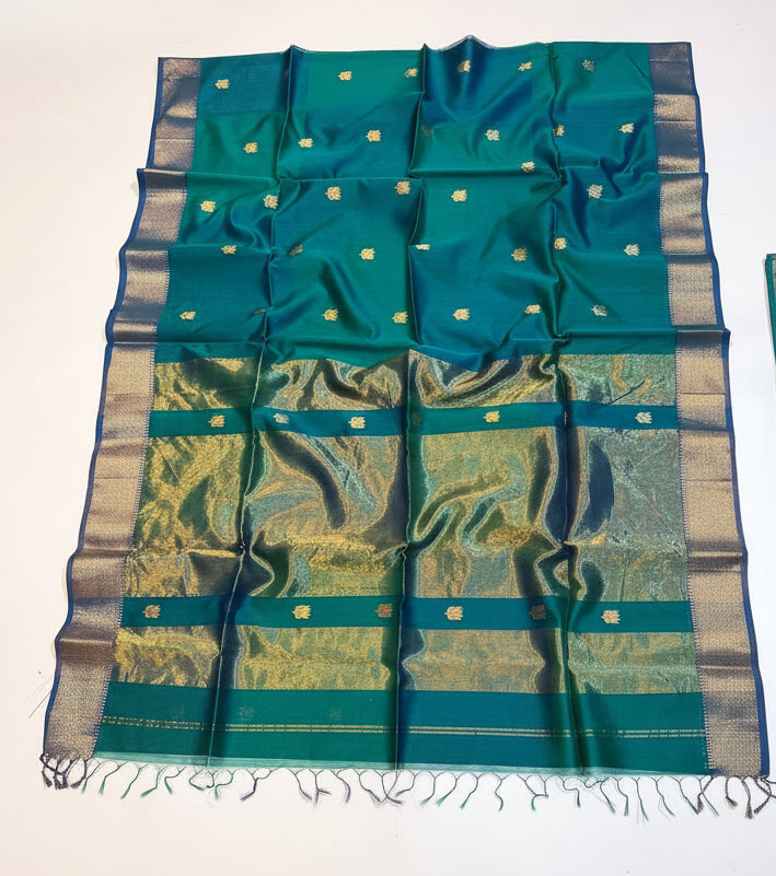 Green and blue patterned fabric with a decorative basket on a white background