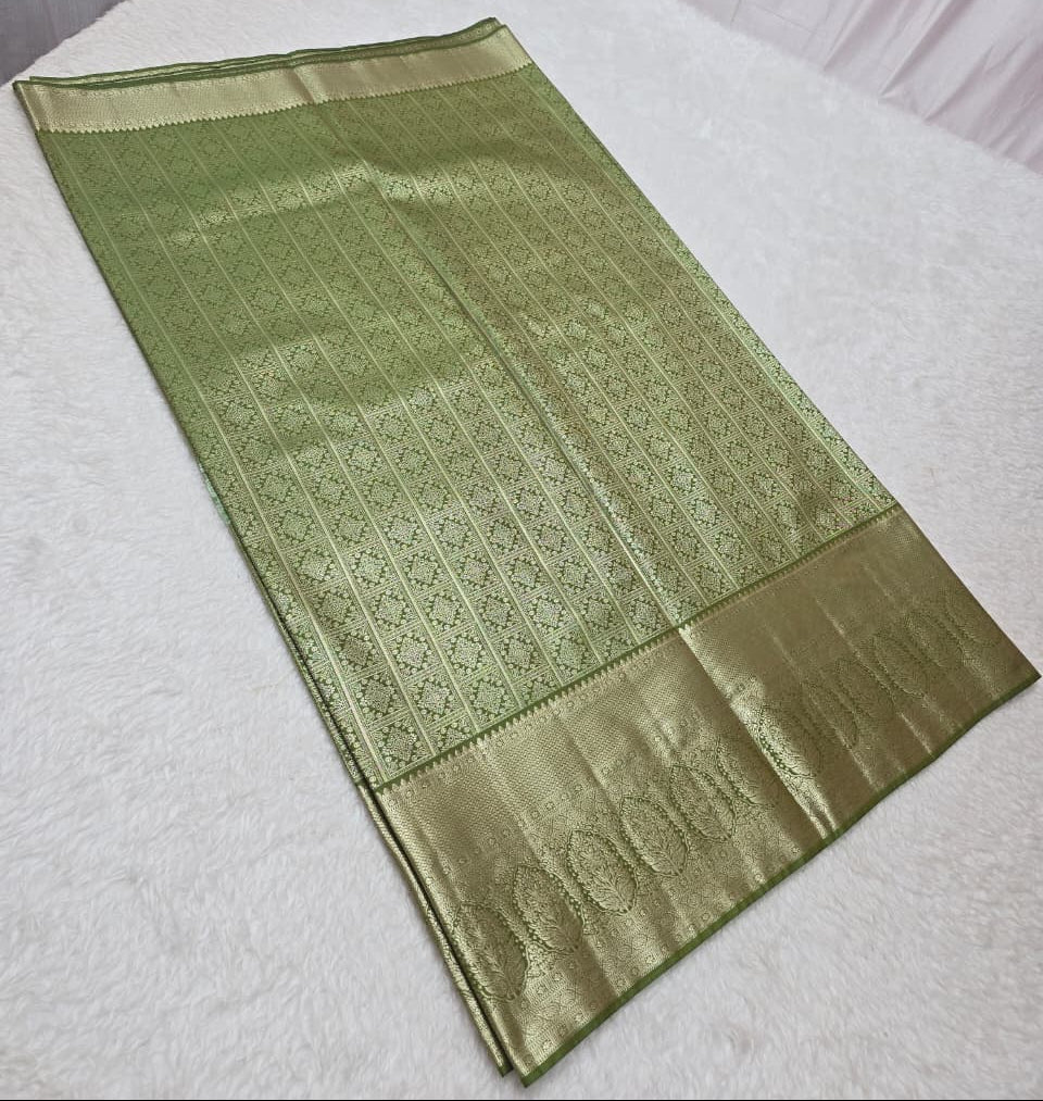 Green saree with a textured pattern on a white surface