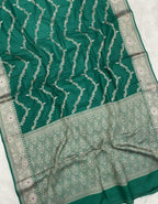 Green saree with silver patterns on a white background