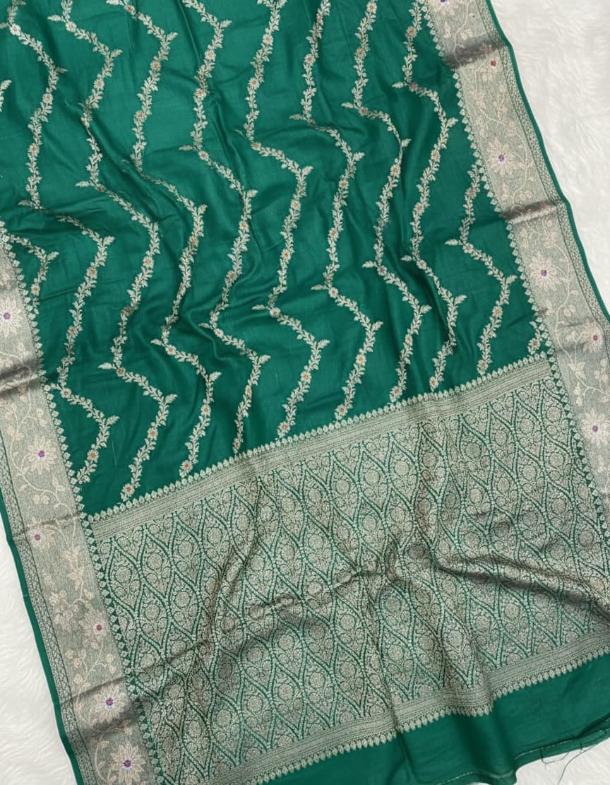 Green saree with silver patterns on a white background