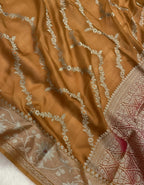 Brown fabric with intricate white embroidery on a white background