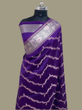Purple saree with white floral patterns on a mannequin against a beige background