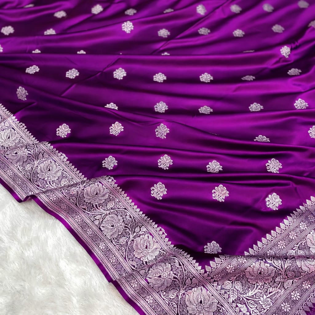 Purple fabric with white floral patterns and intricate border on a white background