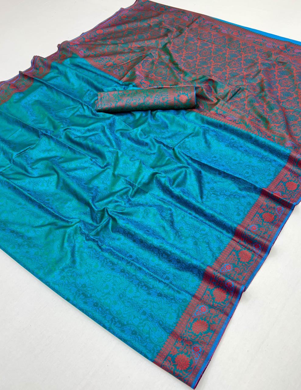 Blue saree with red border on a white background