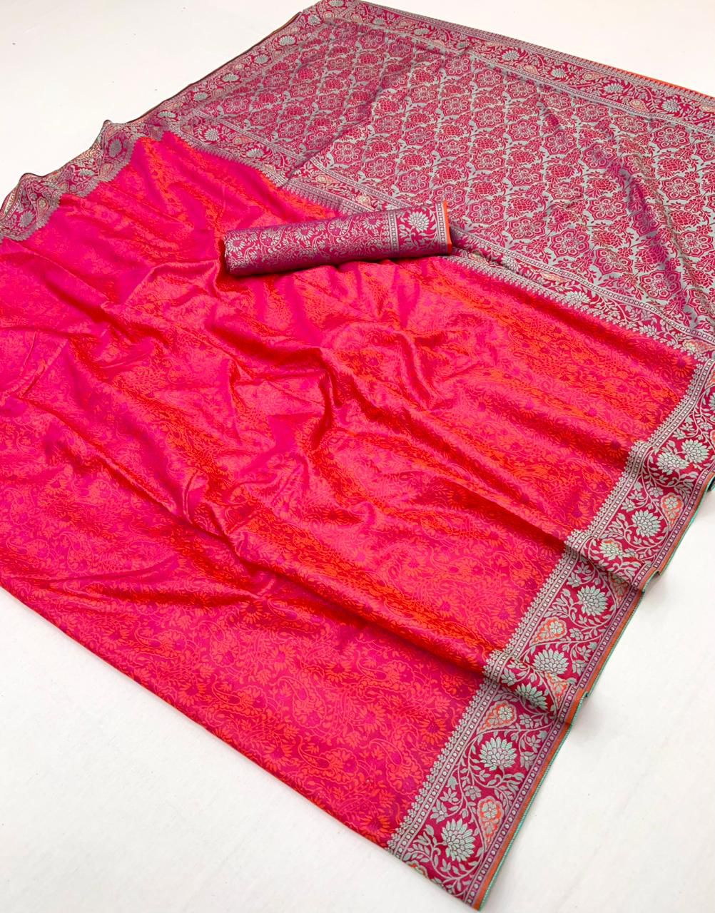 Pink saree with intricate patterns on a white background