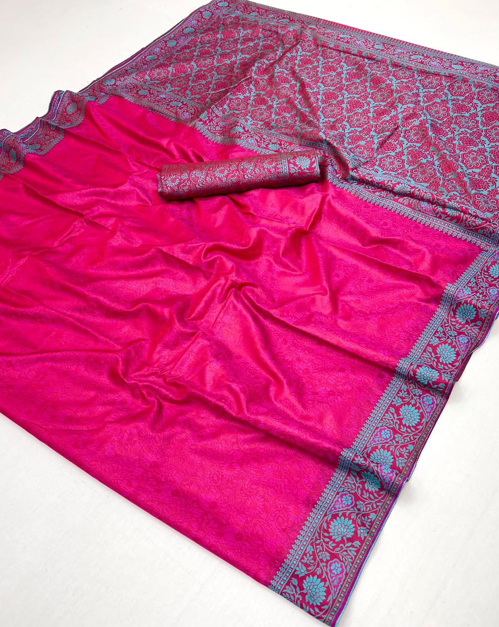 Pink saree with blue floral patterns on a white background