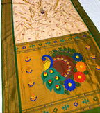 Traditional saree with peacock and floral design on a yellow background