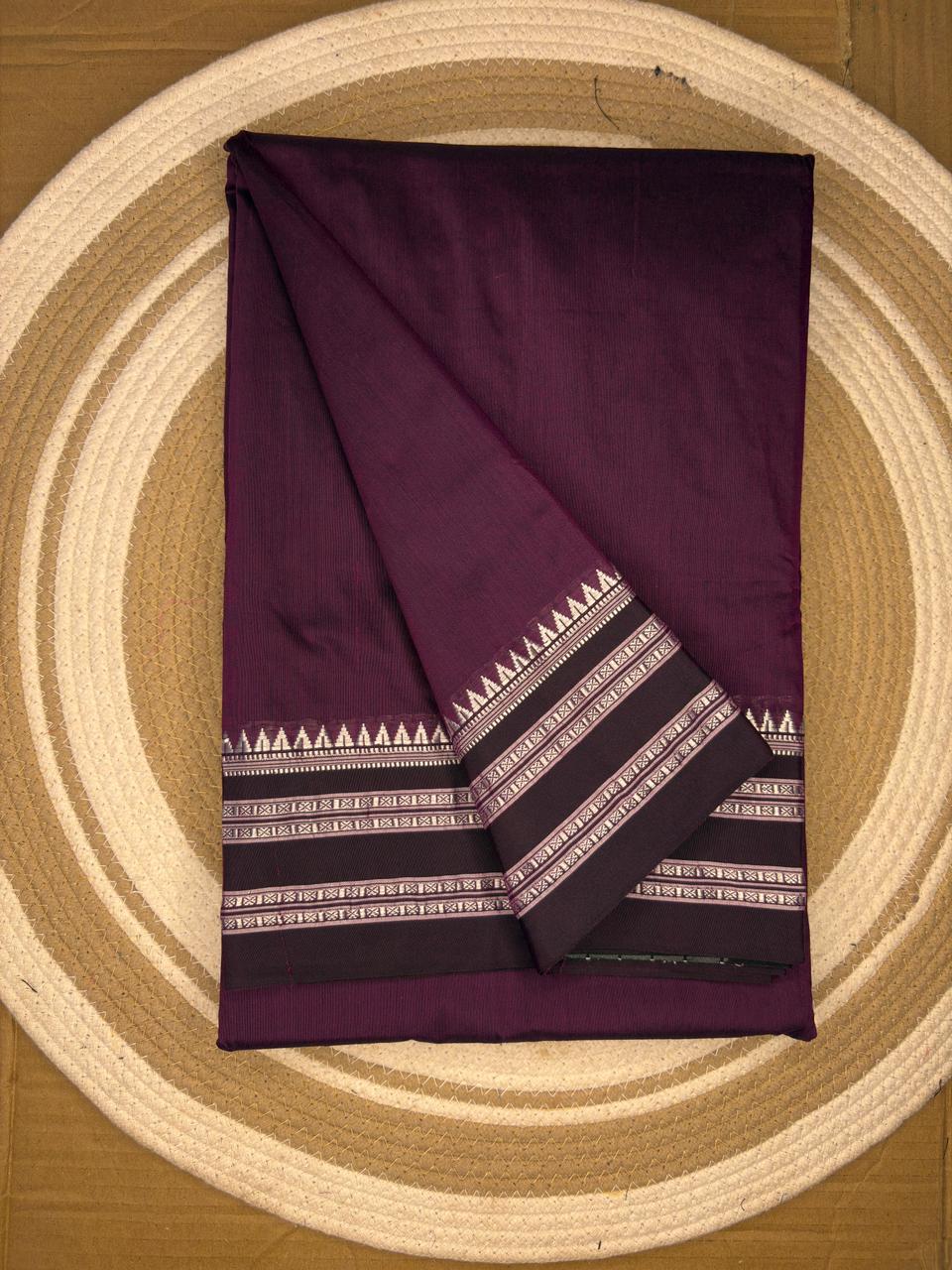 Purple fabric with white patterns on a circular wooden surface