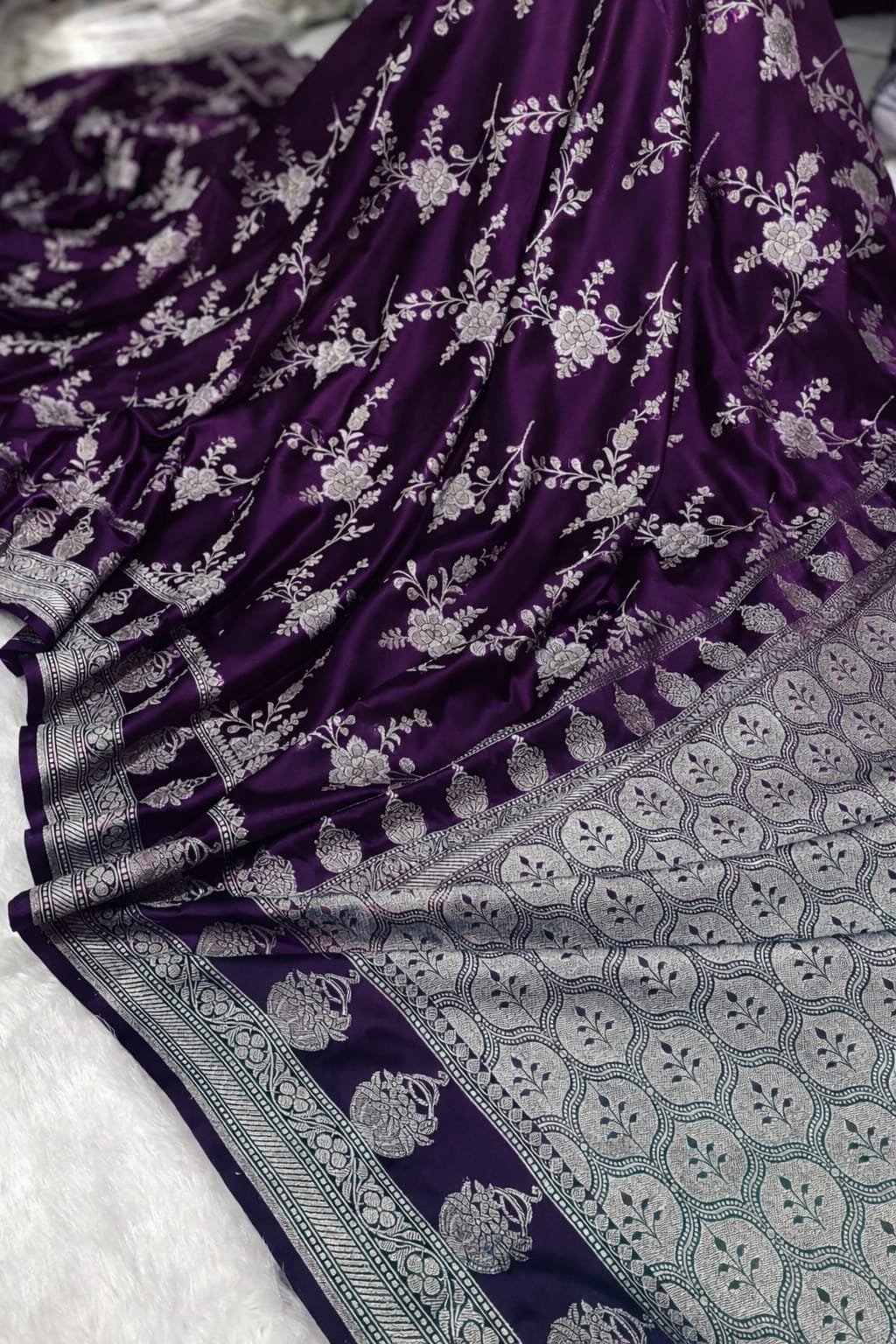 Purple saree with white floral patterns on a white background