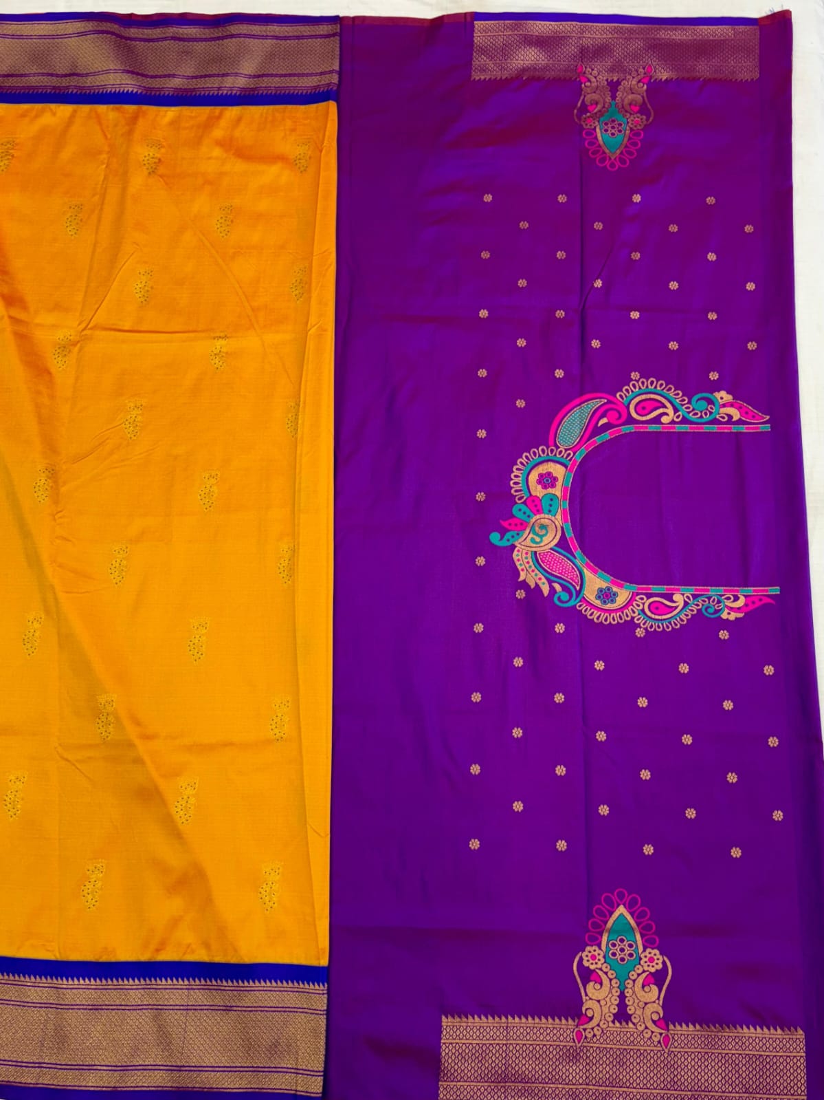 Purple saree with yellow border and decorative patterns