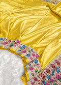 Yellow saree with floral patterns on a white background