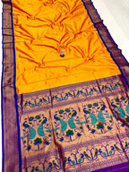 Yellow saree with peacock patterns on a purple background