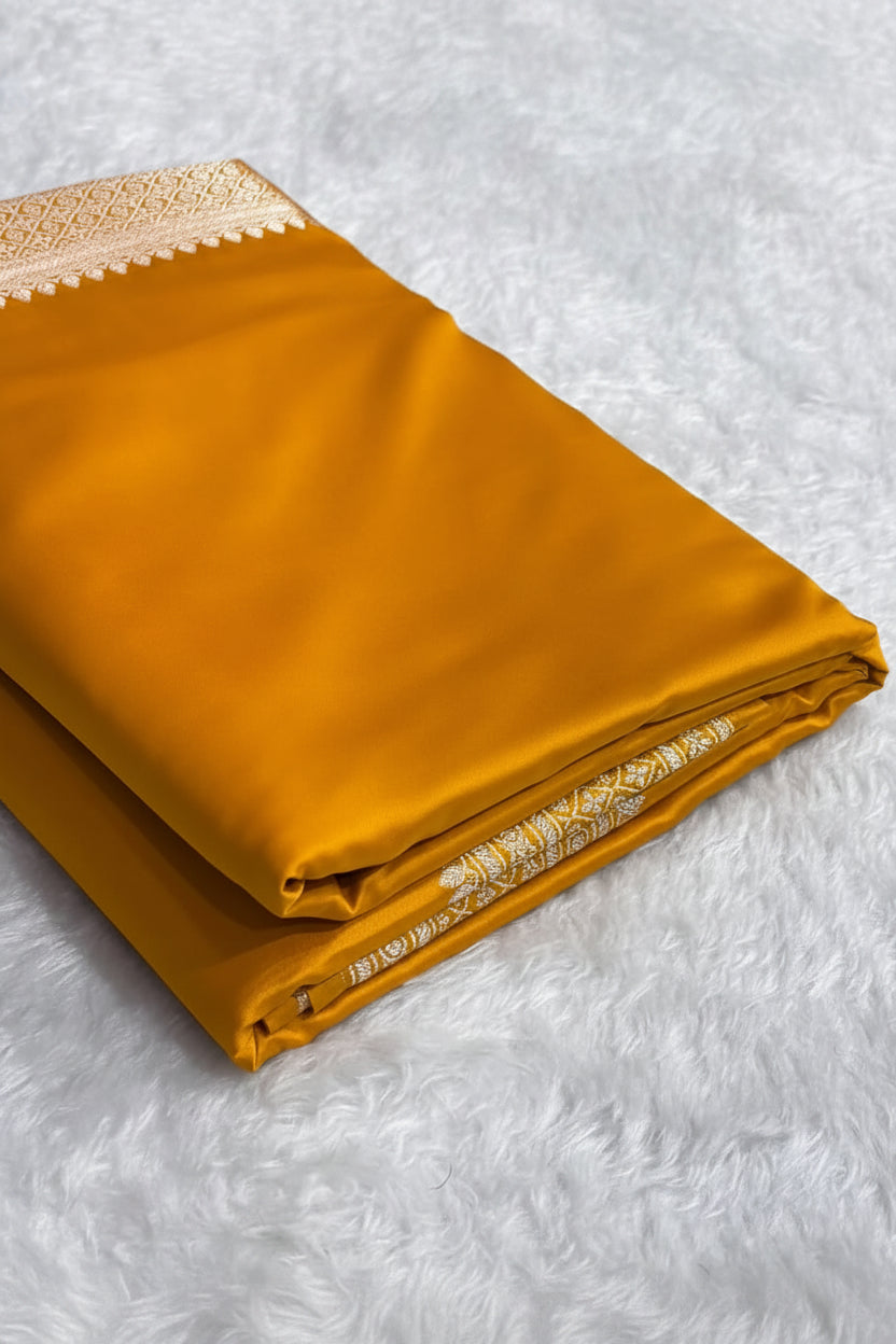 Folded mustard yellow fabric with a pattern on a white surface, Zara box visible.