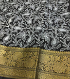 Black fabric with white floral patterns and gold border