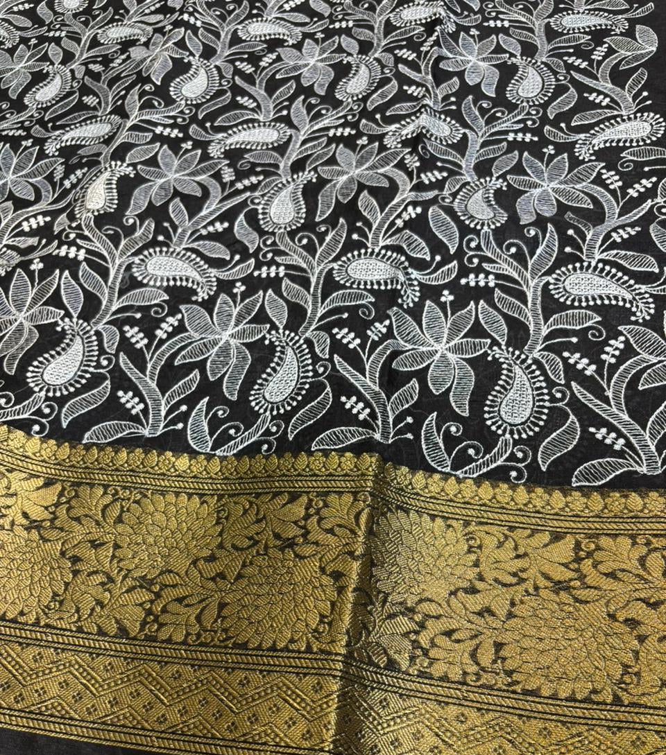 Black fabric with white floral patterns and gold border