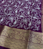 Purple fabric with white floral patterns and gold border
