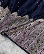 Navy blue fabric with intricate white patterns on a white surface