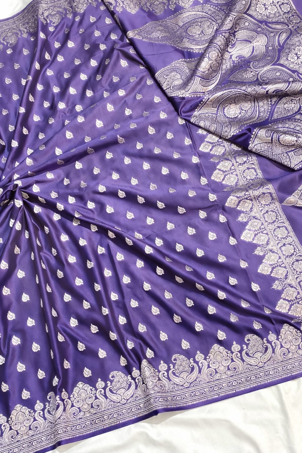 Purple fabric with white patterns on a white background